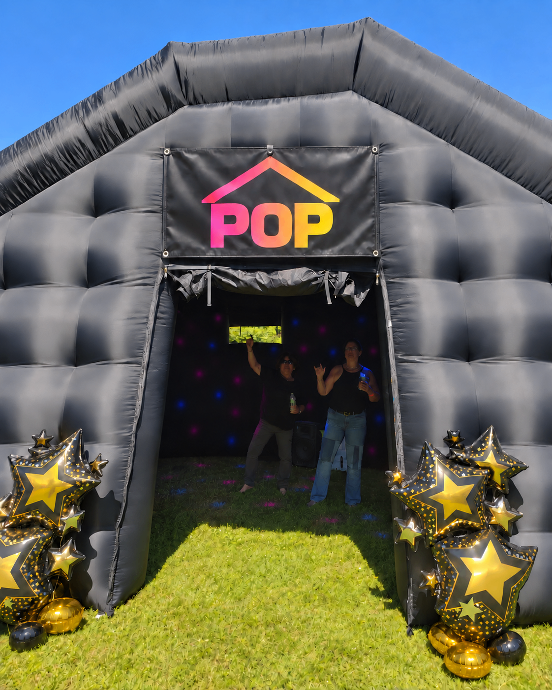 PopHaus inflatable nightclub entrance with POP banner and gold star balloons
