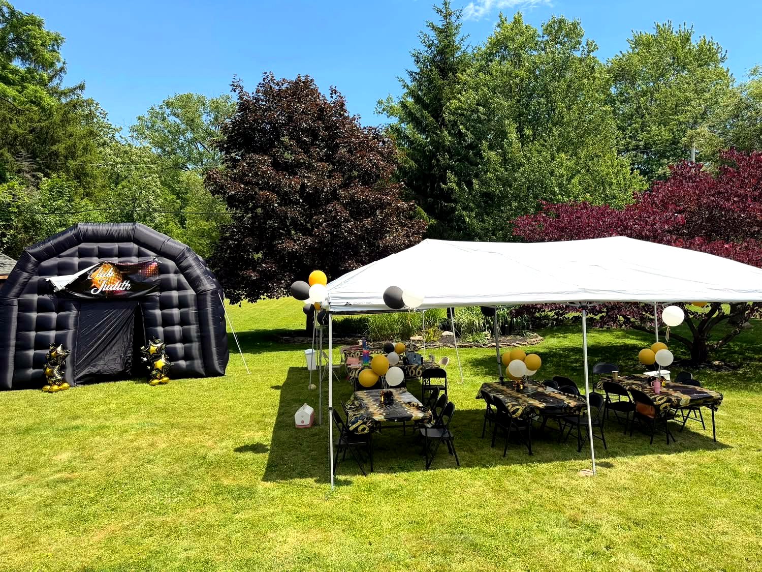 PopHaus inflatable nightclub set up in a backyard with party tent and tables