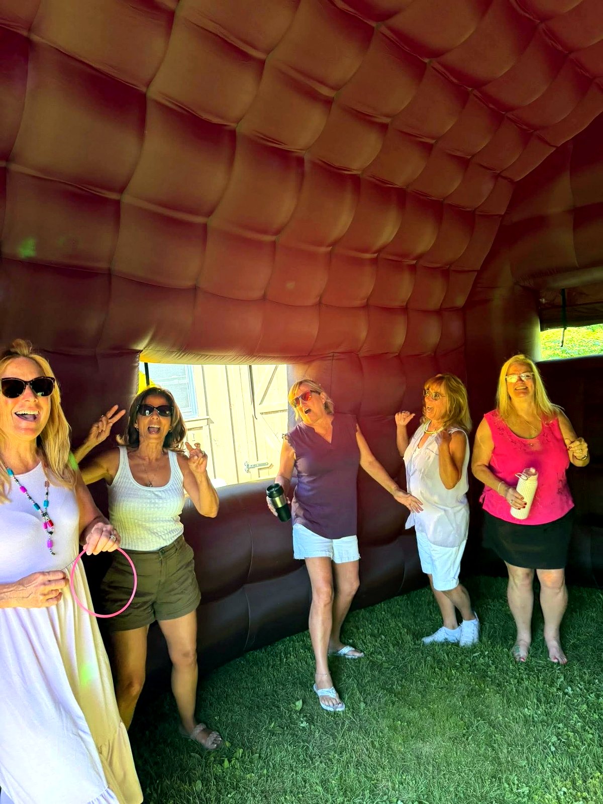 Guests partying inside the inflatable club with red interior lighting