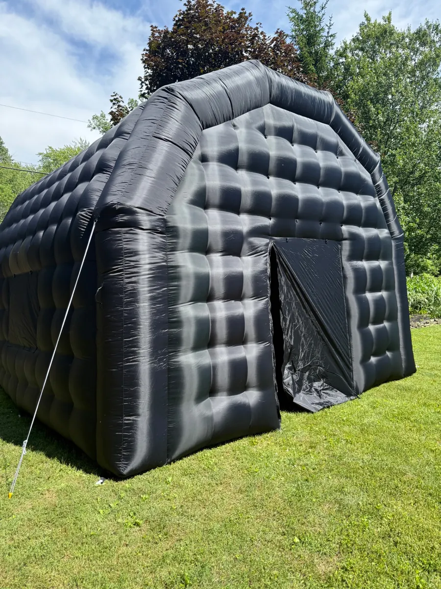 Black PopHaus inflatable nightclub set up on a lawn